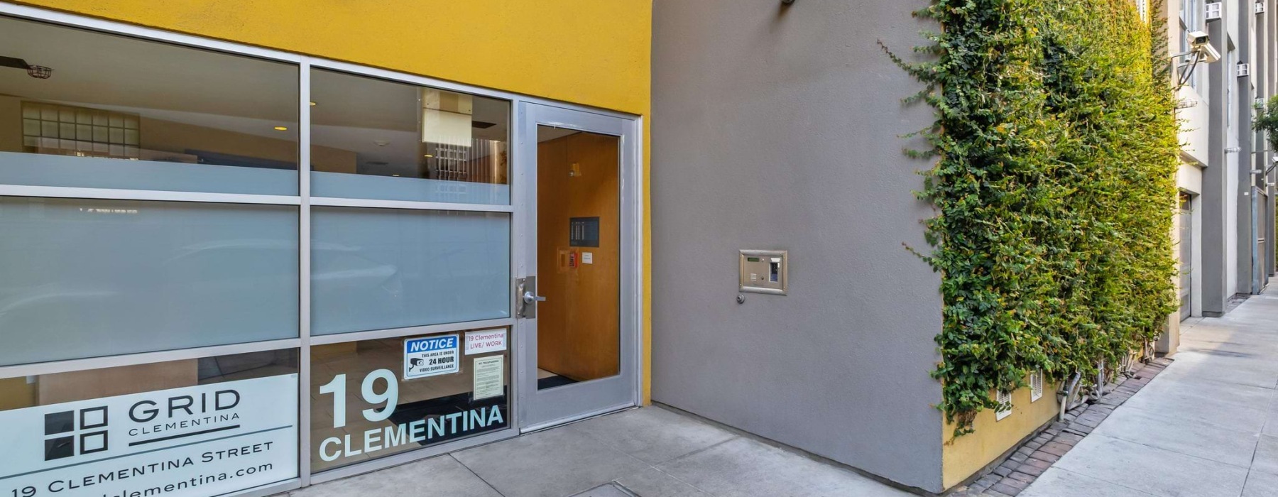 yellow and green door outside of The Grid Clementina