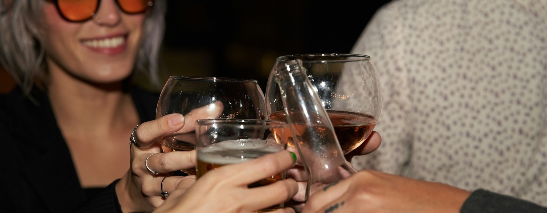 a couple of women holding glasses of wine