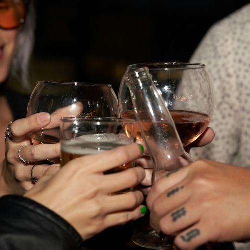 a couple of women holding glasses of wine